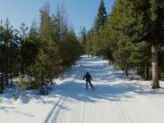 A person skiis across a trail around John Day